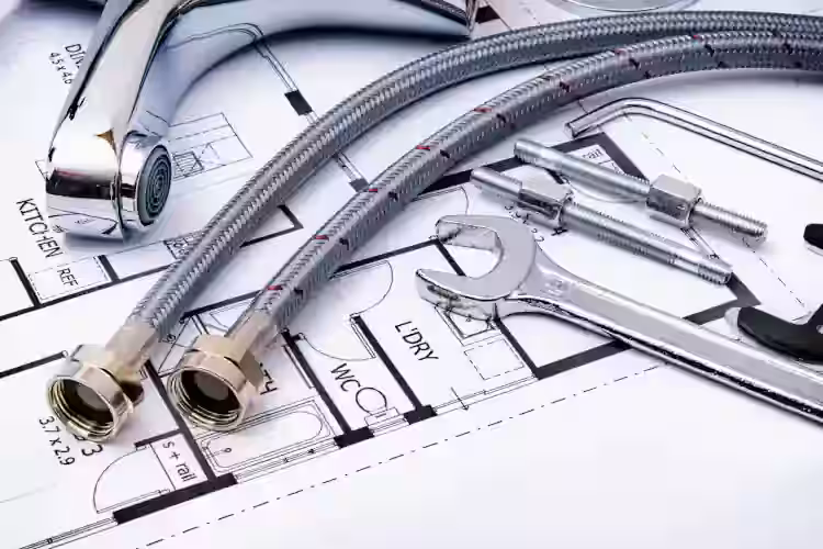 Professional plumber working under a kitchen sink